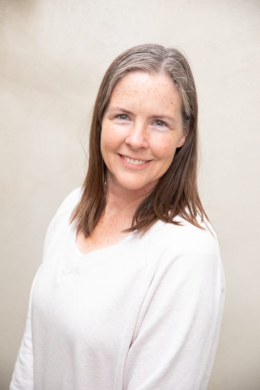 KatieGow gray haired, kind woman in cream sweater